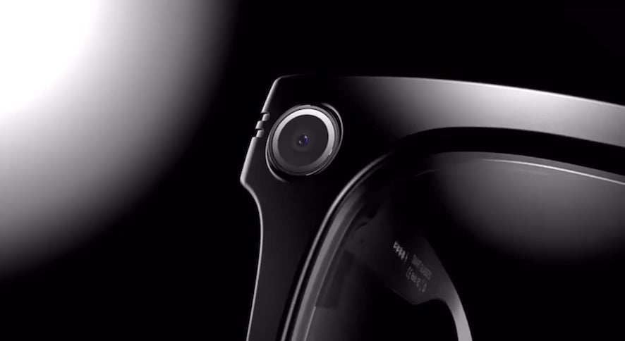 Load video: Close-up video of AI smart glasses levitating in mid-air, showcasing the built-in HD camera on the frame’s edge, highlighting premium design and advanced wearable technology
